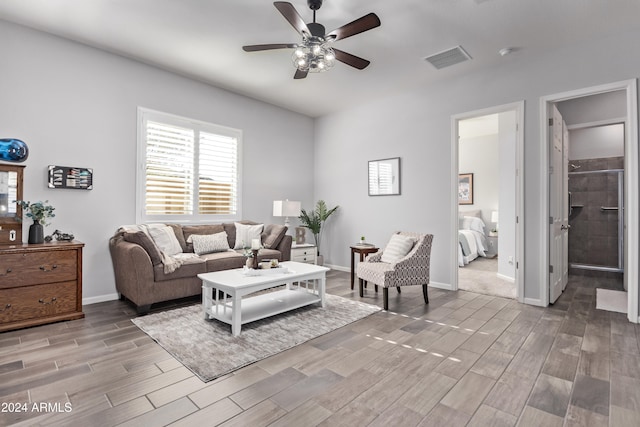 living room featuring light wood-type flooring and ceiling fan