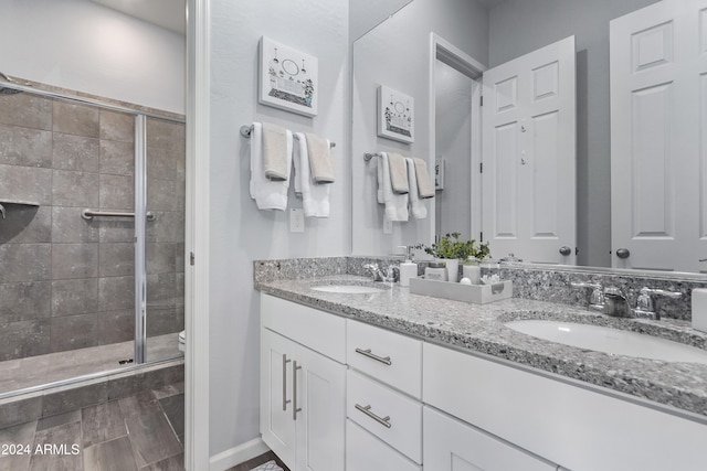 bathroom with walk in shower, vanity, and toilet