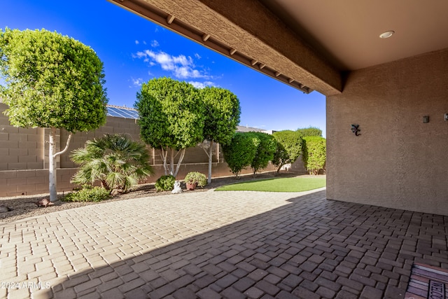 view of patio featuring a lanai