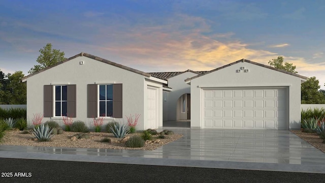 ranch-style house featuring a garage, stucco siding, and concrete driveway