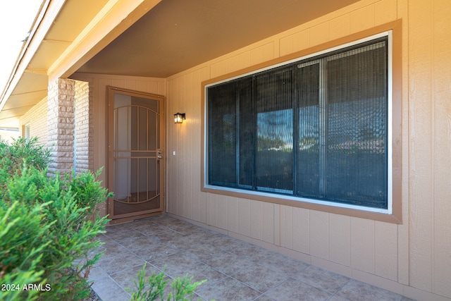 view of exterior entry featuring a patio