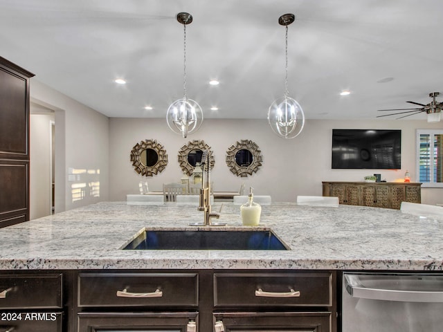 kitchen featuring sink, decorative light fixtures, stainless steel dishwasher, ceiling fan, and dark brown cabinets