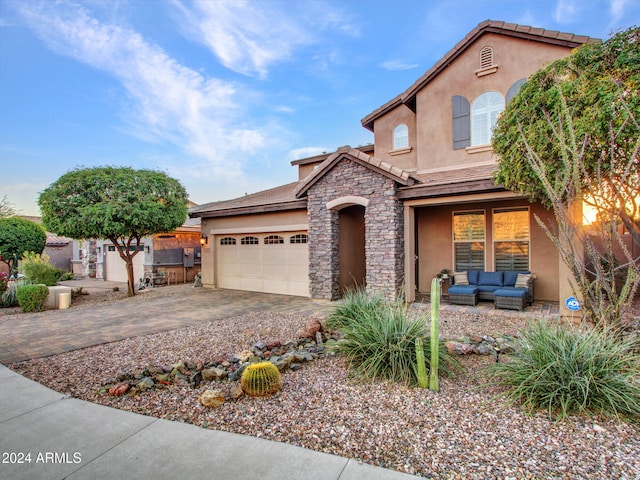 view of front of home featuring an outdoor living space and a garage