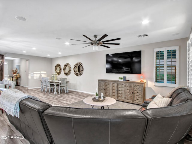 living room with ceiling fan and hardwood / wood-style flooring