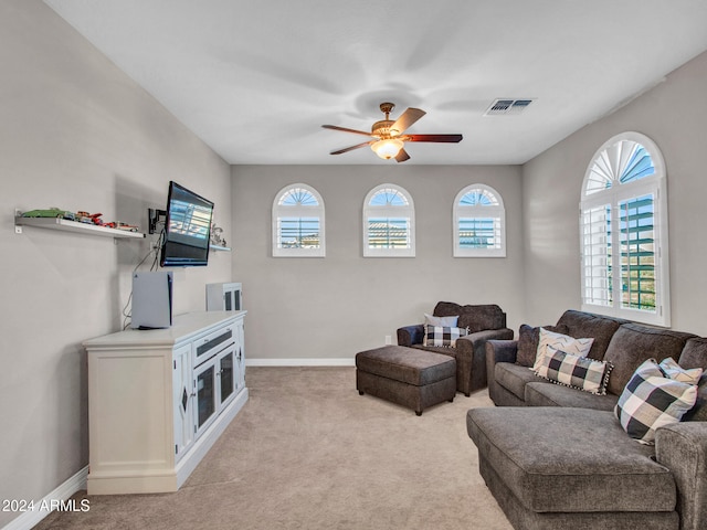 carpeted living room featuring ceiling fan