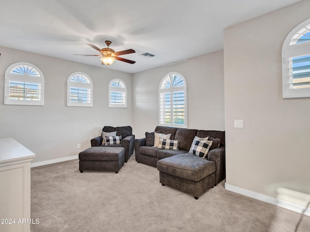 carpeted living room featuring ceiling fan and a healthy amount of sunlight