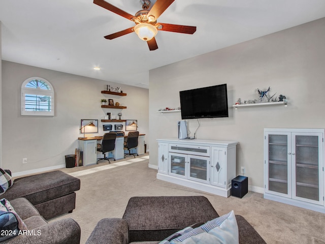 carpeted living room with ceiling fan