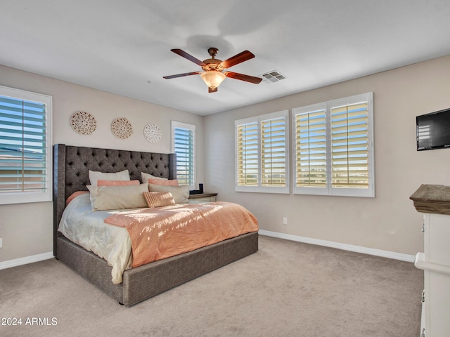 bedroom featuring ceiling fan and light colored carpet