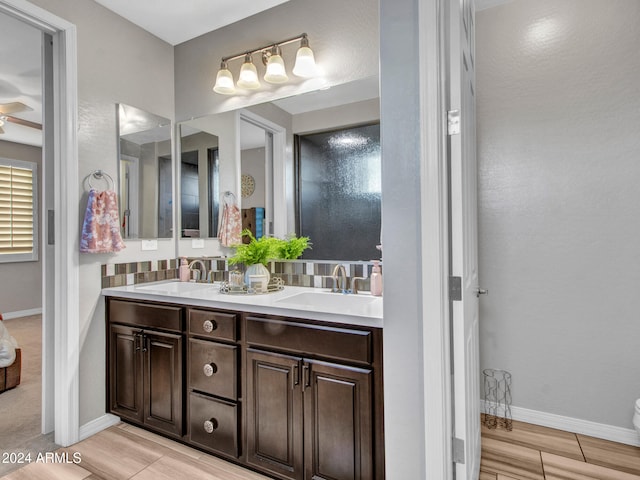 bathroom featuring wood-type flooring, vanity, and ceiling fan