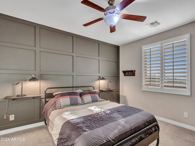 bedroom featuring light colored carpet and ceiling fan