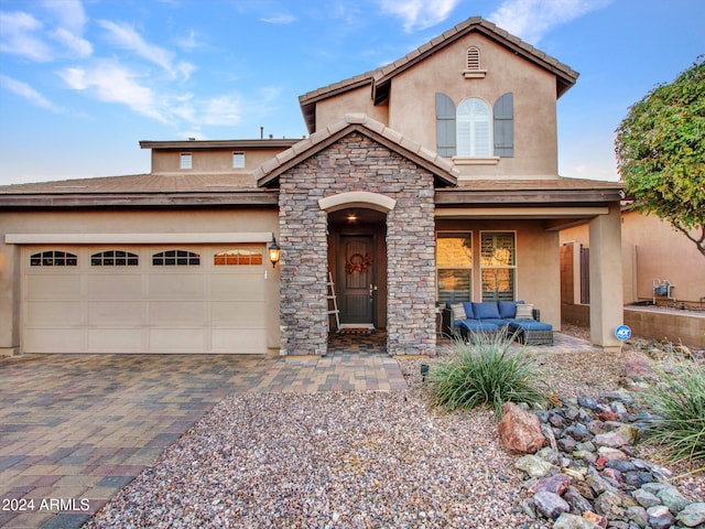 view of front of home with outdoor lounge area and a garage