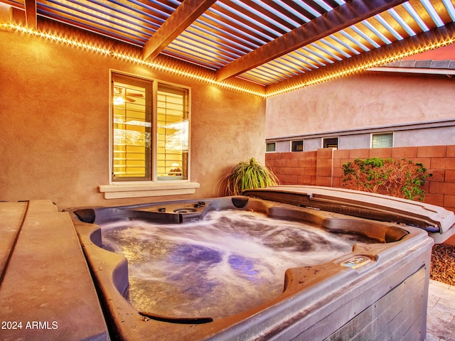 view of patio with a pergola and a hot tub