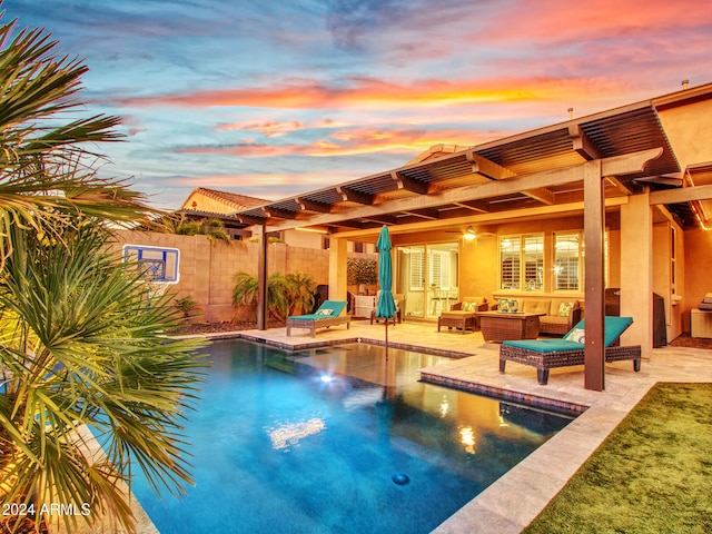 pool at dusk with outdoor lounge area and a pergola