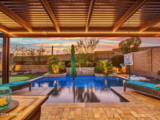 view of pool at dusk