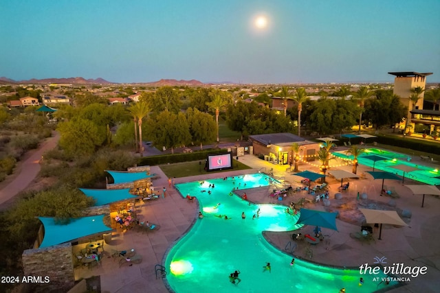 view of pool at dusk