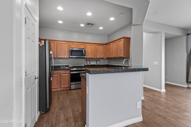 kitchen featuring hardwood / wood-style floors and stainless steel appliances