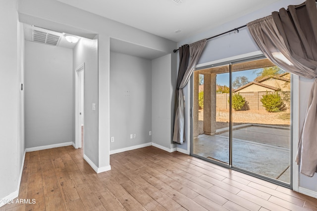 spare room featuring light hardwood / wood-style flooring