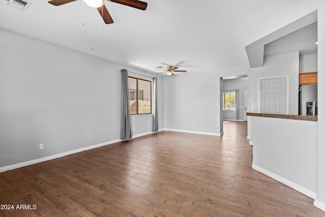 unfurnished living room featuring light hardwood / wood-style floors and ceiling fan