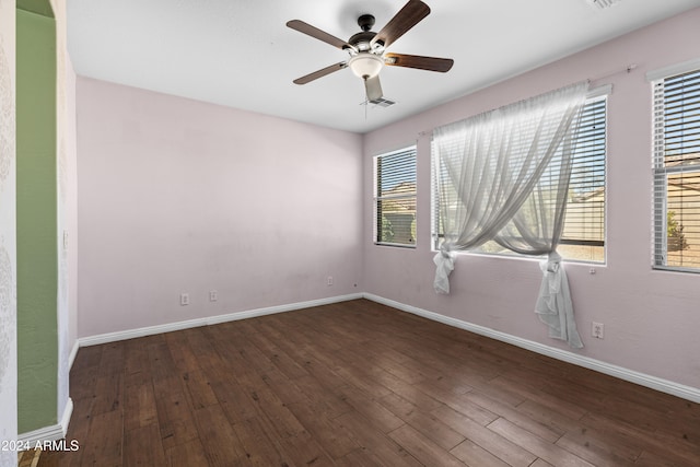 spare room with ceiling fan and dark hardwood / wood-style floors