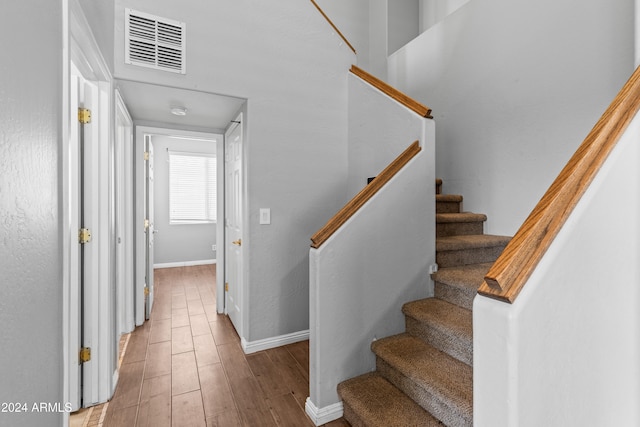 stairs featuring hardwood / wood-style flooring