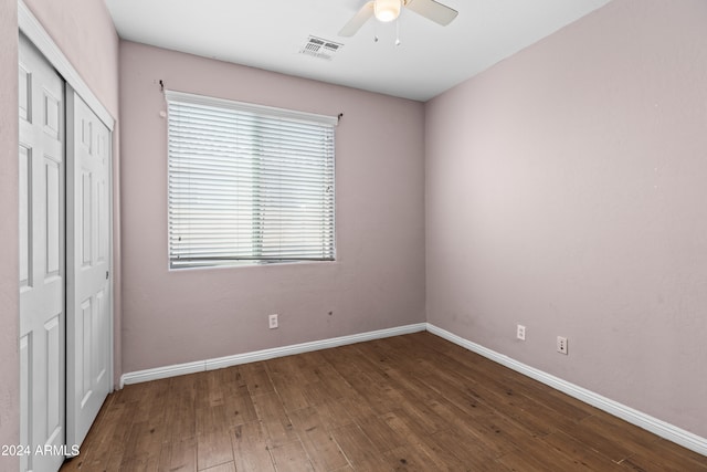 unfurnished bedroom featuring ceiling fan, a closet, and wood-type flooring