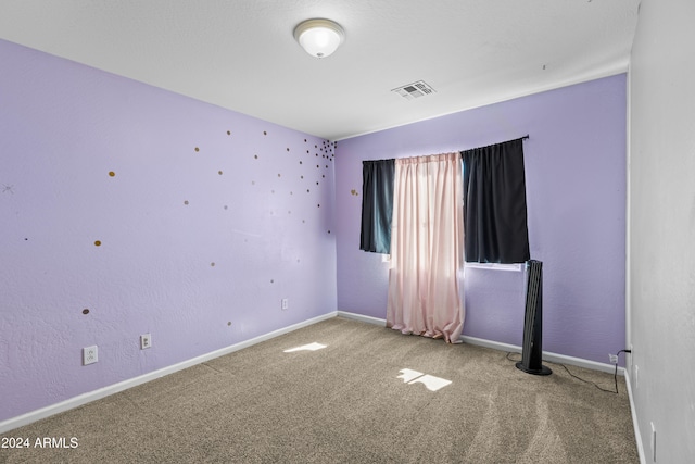 spare room featuring carpet