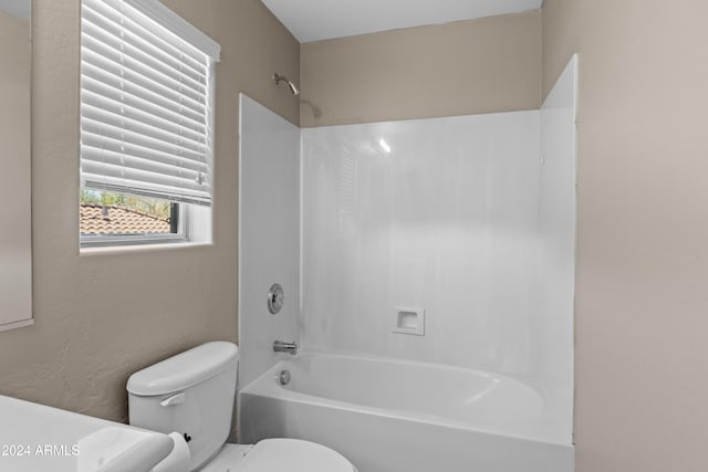 bathroom with shower / bathtub combination and toilet