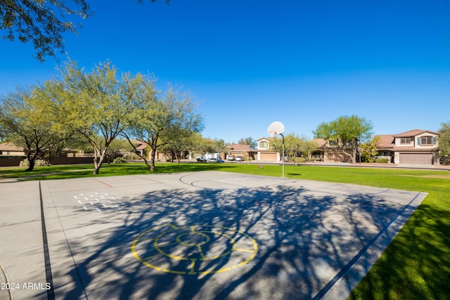 view of sport court featuring a yard