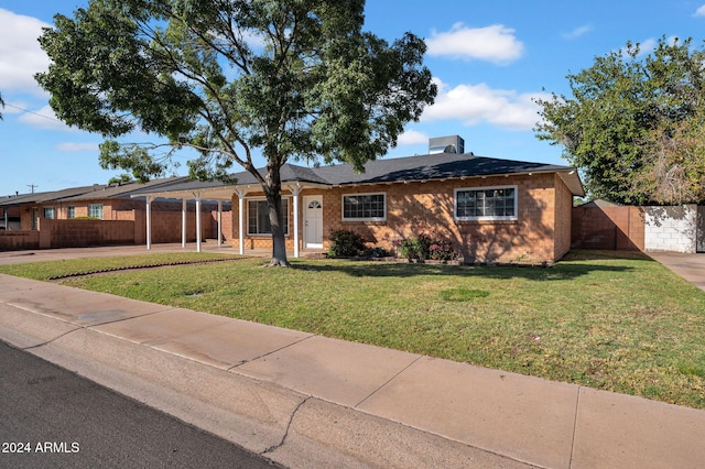 ranch-style house featuring a front yard