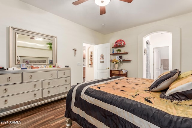 bedroom featuring dark hardwood / wood-style floors, ceiling fan, and ensuite bathroom