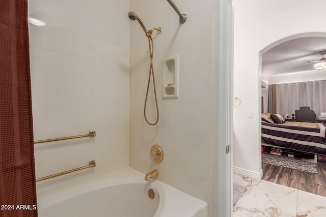 bathroom with ceiling fan and shower / bath combo with shower curtain