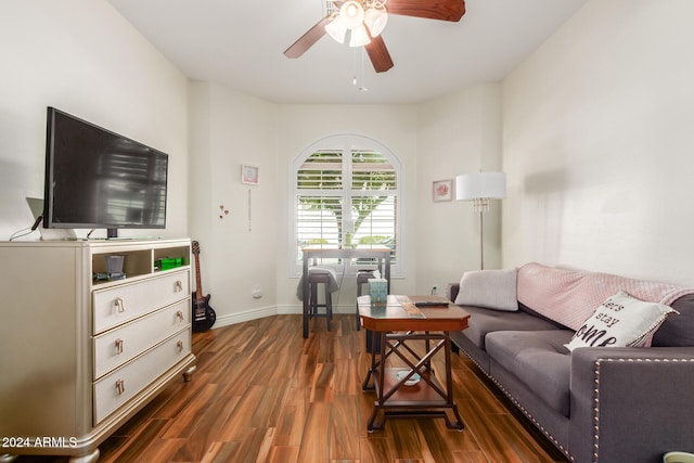 living room with ceiling fan and dark wood-type flooring