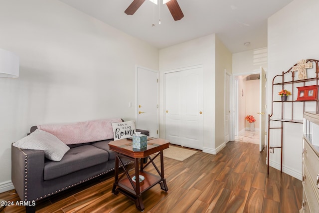 living room featuring dark hardwood / wood-style flooring and ceiling fan