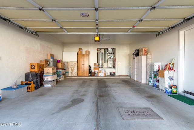 garage with water heater and a garage door opener