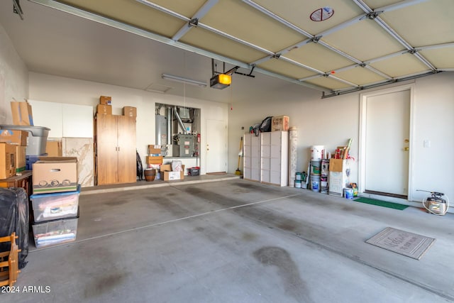 garage featuring gas water heater and a garage door opener