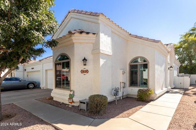 mediterranean / spanish-style home with a garage