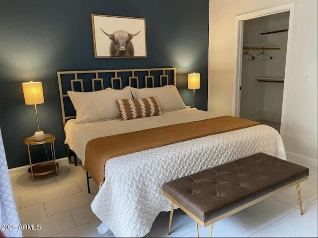 9451 E Becker Ln Unit 1051, Scottsdale, AZ 85260 - bedroom featuring tile patterned flooring, baseboards, a closet, and a spacious closet