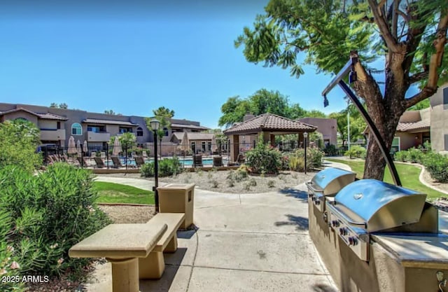 9451 E Becker Ln Unit 1051, Scottsdale, AZ 85260 - view of home's community with a gazebo, a residential view, a patio area, and a swimming pool