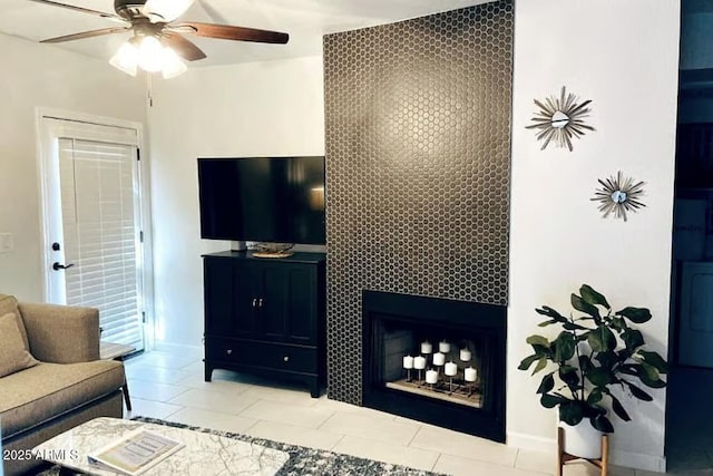 9451 E Becker Ln Unit 1051, Scottsdale, AZ 85260 - living area with a ceiling fan, a fireplace, tile patterned flooring, and baseboards