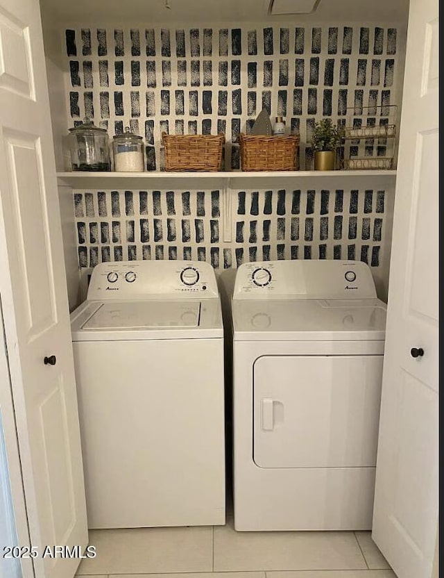 9451 E Becker Ln Unit 1051, Scottsdale, AZ 85260 - laundry area with washer and clothes dryer and light tile patterned floors