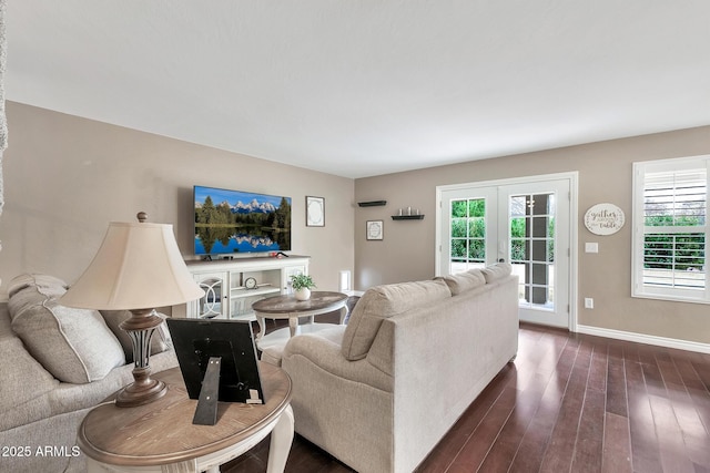 living room featuring french doors, dark hardwood / wood-style flooring, and a wealth of natural light