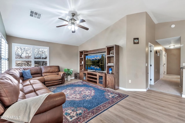 living room with ceiling fan, light hardwood / wood-style floors, and vaulted ceiling