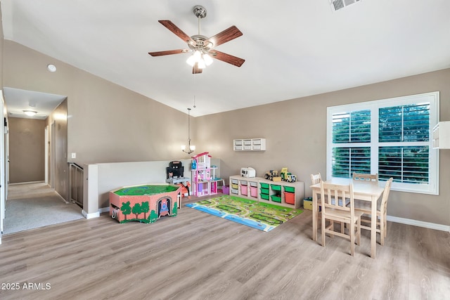 game room with light hardwood / wood-style floors, ceiling fan, and lofted ceiling