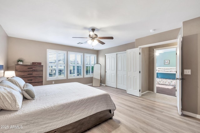 bedroom featuring ceiling fan, light hardwood / wood-style floors, and a closet