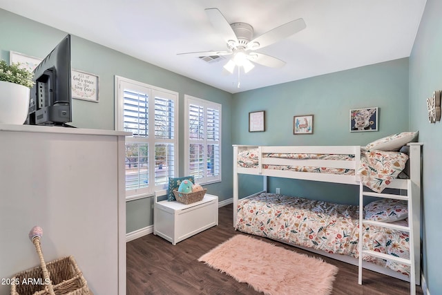 bedroom with multiple windows, dark hardwood / wood-style flooring, and ceiling fan