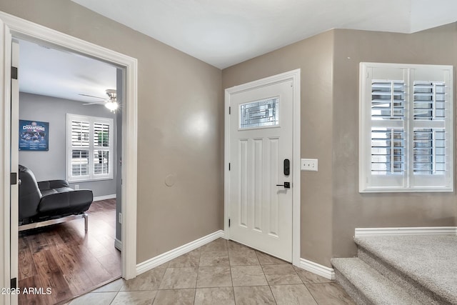 entrance foyer with light tile patterned floors and ceiling fan