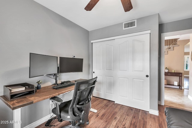 home office featuring ceiling fan and dark wood-type flooring