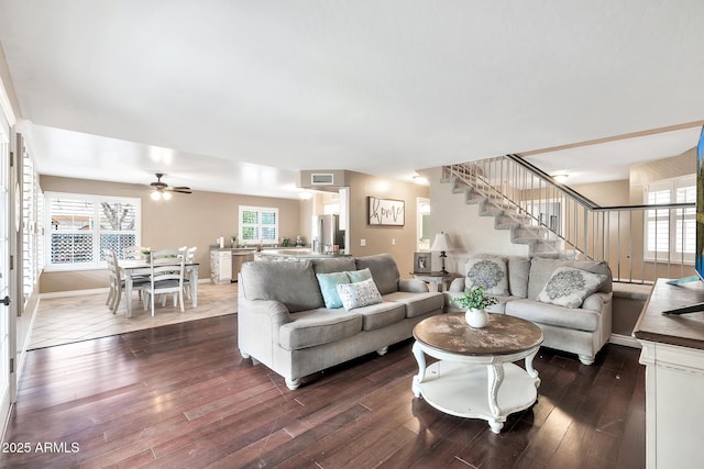 living room with ceiling fan and dark wood-type flooring