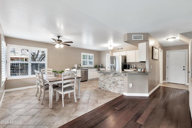 dining room with light hardwood / wood-style flooring and ceiling fan