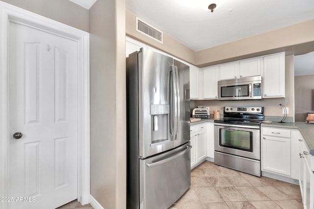 kitchen featuring appliances with stainless steel finishes and white cabinetry